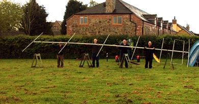 TDARS members pose with the 6m beam on the village field
